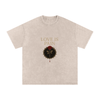 Front view of Love Is Pain graphic t-shirt showing bleeding rose wrapped in barbed wire – Stitro unisex design Apricot

