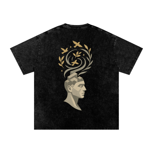 Back design showing Mind Bloom motif – an artistic male silhouette with birds and leaves emerging from the mind, printed on oversized washed tee – Black

