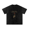 Front print of Masked Silence tee showing skeleton hand holding red rose beneath a silent quote on washed black cotton Black

