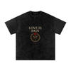Front view of Love Is Pain graphic t-shirt showing bleeding rose wrapped in barbed wire – Stitro unisex design black

